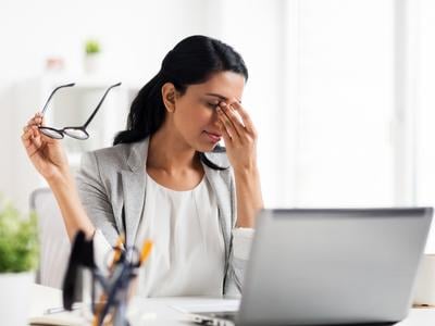 tired woman worker due to allergies at office