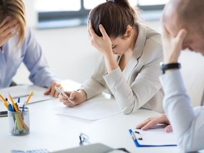 Blog - small business people under stress at office reviewing reports